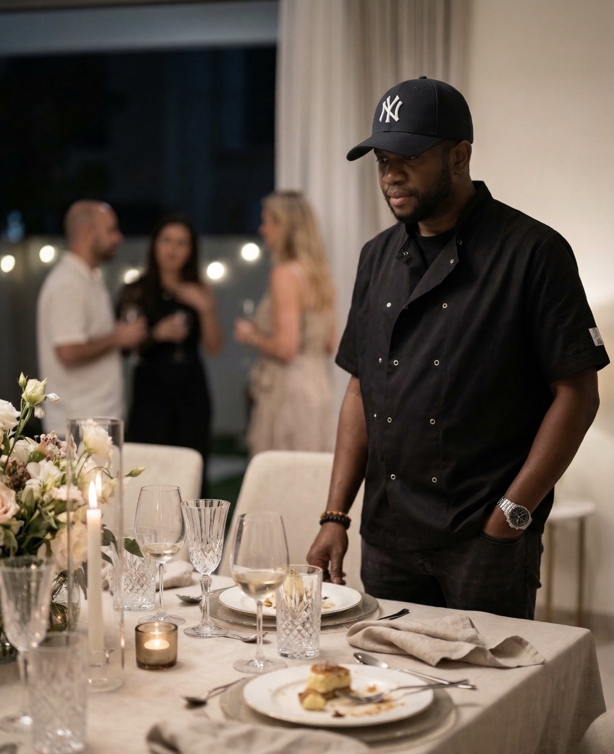 Chef Doric Sinclair surveying an elegantly set private dining table